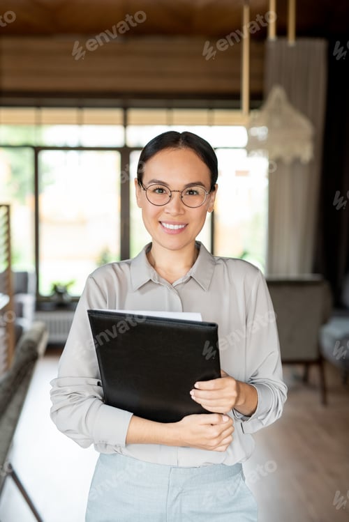 Preview: Happy young elegant owner of luxurious restaurant with menu looking at you
