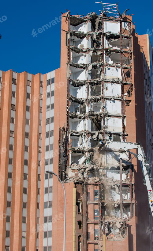 Preview: An excavator amidst a dusty demolition site
