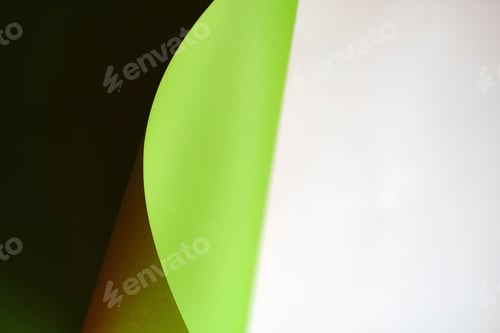 Preview: green wave from paper on white background with copy space. Concepts: lines and geometry. defocus