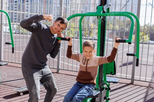 Preview: Father and son in the street gym in the park.