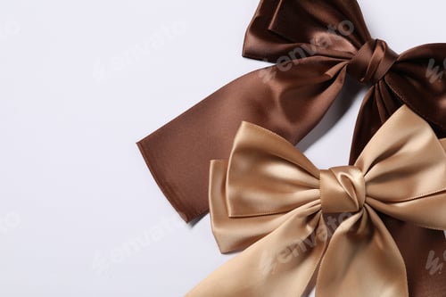 Preview: Beautiful hair bows on white background, flat lay. Space for text