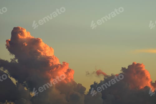 Preview: White fluffy cumulonimbus clouds forming before thunderstorm on evening sky.