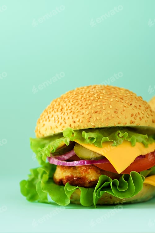 Preview: Macro view of tasty burger with beef, cheese, lettuce, onion, tomatoes on blue background. Close up