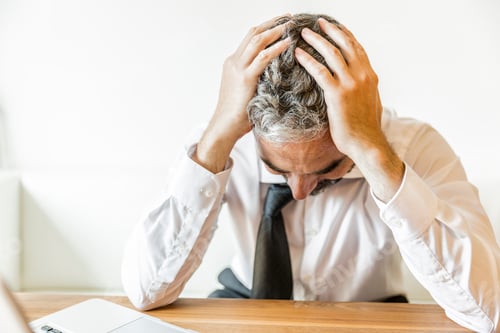 Preview: Overstressed businessman with head in his hands