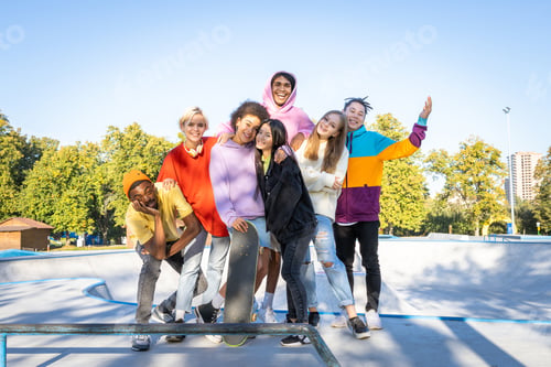 Preview: Multiracial group of young friends bonding outdoors