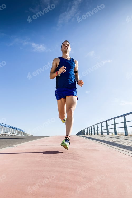 Preview: Handsome young man running in the park.