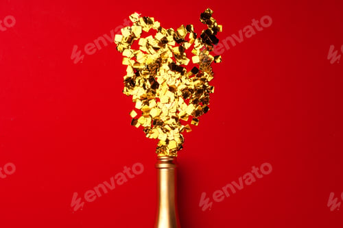 Preview: Champagne bottle with sparkling confetti on red background flat lay