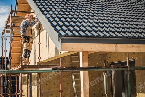 Preview: Construction Worker Installing Roof Tiles on New House Under Clear Blue Sky