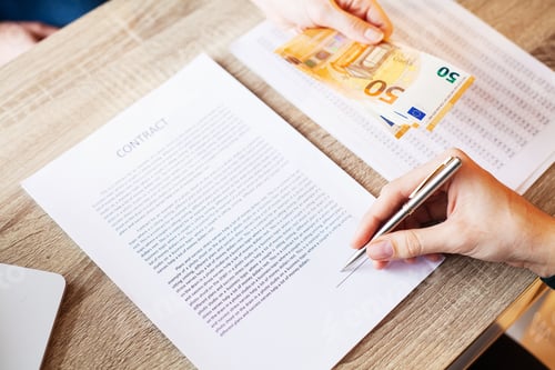 Preview: Businessman giving money while making deal to agreement a real estate contract
