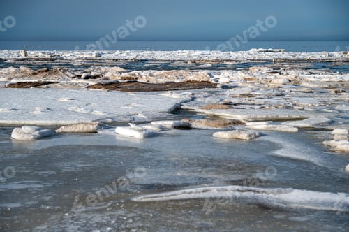 Preview: Winter landscape shows ice floating on water in an open lake during daytime