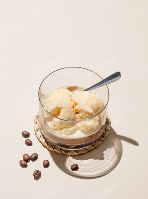 Preview: Affogato coffee with vanilla ice cream scoops and espresso in a glass on a light background