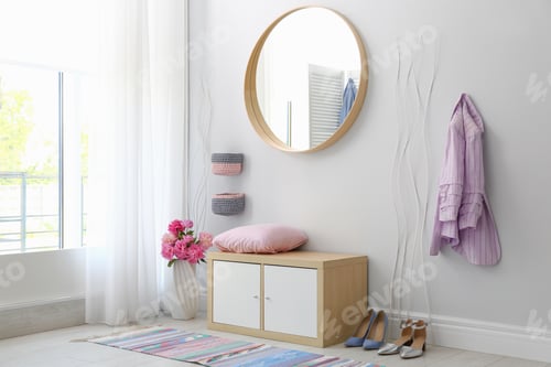Preview: Stylish hallway interior with round mirror on white wall