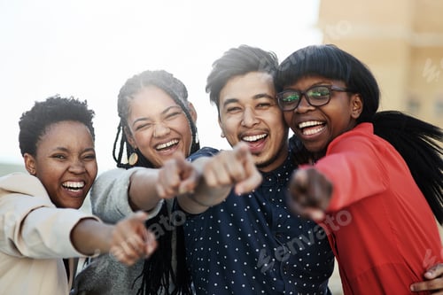 Preview: We want you. Portrait of a group of happy students pointing toward the camera.