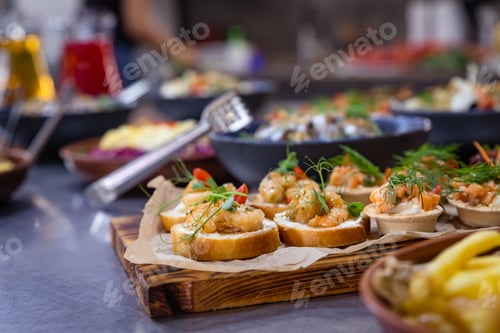 Preview: Banquet table served for holiday with canape and different snacks. European food. Catering.