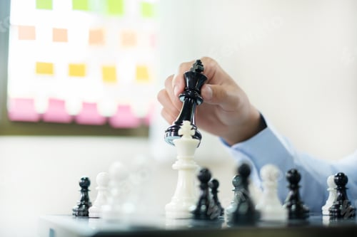 Preview: hand of businessmen moving chess in competition shows leadership, followers, and business success