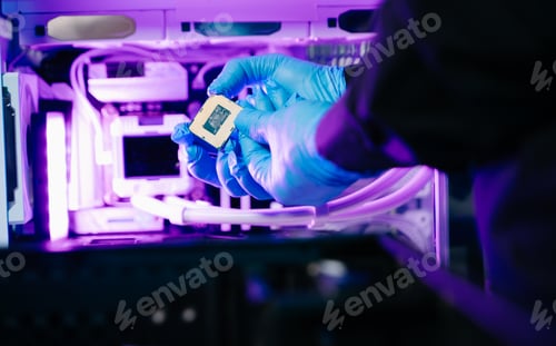 Preview: The technician is putting the CPU on the socket of the computer motherboard.