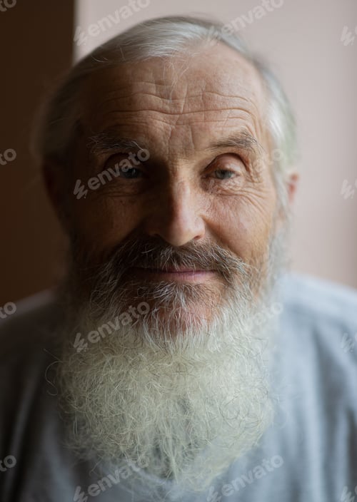 Vorschau: Nahaufnahme eines alten Seniors mit langem grauem Bart, der in die Kamera blickt