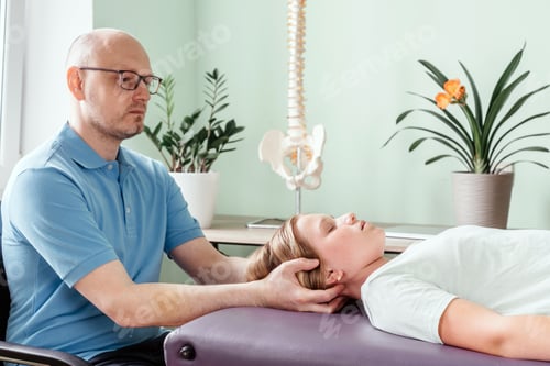 Preview: A girl receiving CST treatment by osteopath practitioner using the gentle hands-on technique