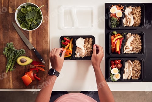 Preview: Overhead Shot Of Woman Preparing Batch Of Healthy Meals At Home In Kitchen