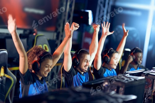 Preview: Team of happy professional cyber sport gamers celebrating success while participating in eSports
