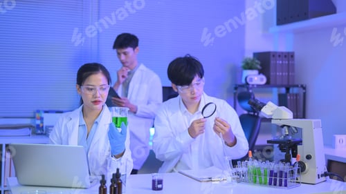 Preview: Researchers team of science. A man research scientist and woman preparing and analyzing microscope