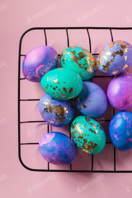 Preview: Easter eggs purple and blue with golds on pink background.