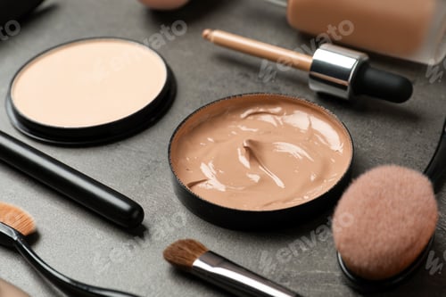 Preview: Composition with skin foundation, powder and beauty accessories on grey background