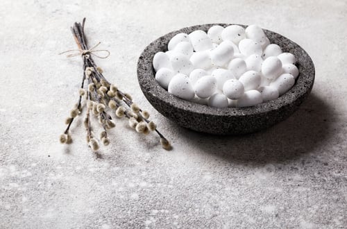 Preview: Easter holiday concept.White small eggs in a plate
