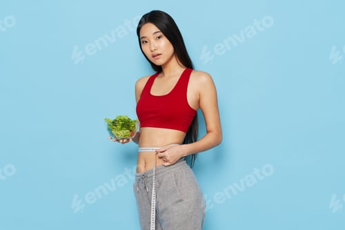 Preview: athletic woman slim figure healthy eating blue background