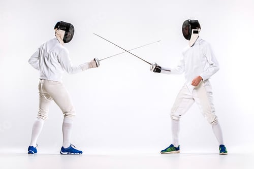 Preview: The two men wearing fencing suit practicing with sword against gray