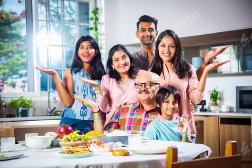 Preview: Happy Indian asian family having lunch at home and posing for photo