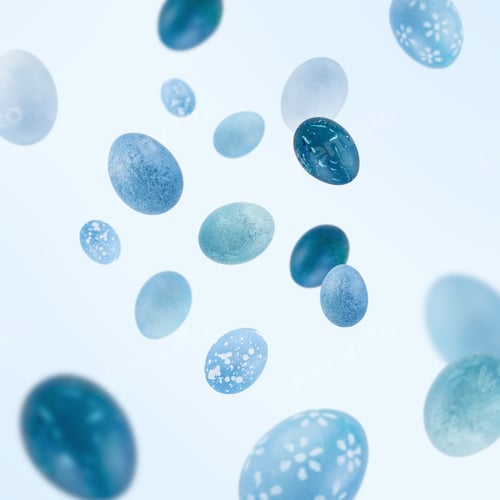 Preview: Blue Easter eggs in motion, flying, against light background
