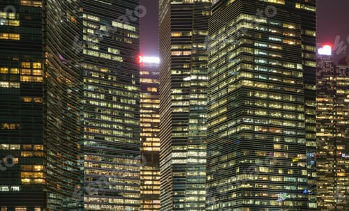 Preview: Pattern of office buildings windows illuminated at night. Lighting with Glass architecture facade