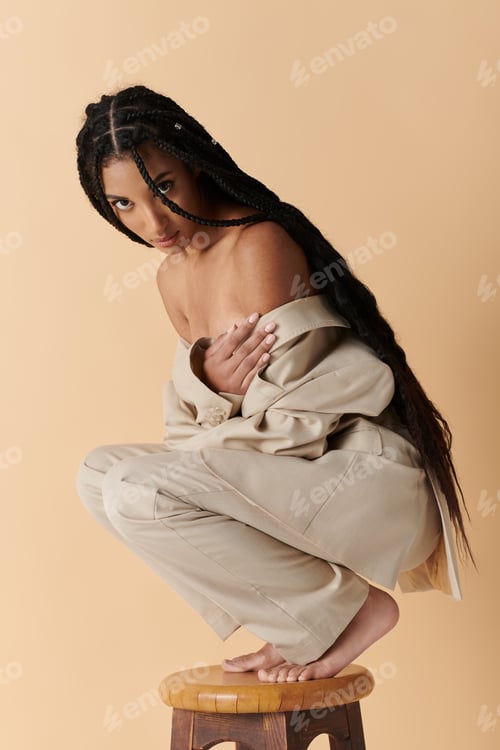 Preview: Stylish woman in beige on a stool