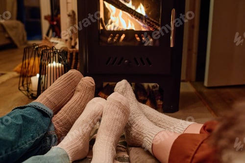 Preview: Unrecognizable Family Relaxing In Front Of Fireplace