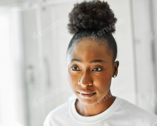 Preview: Thoughtful Woman Posing Indoors with Afro Bun