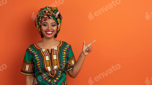 Preview: Pretty african woman showing copy space for advertisement