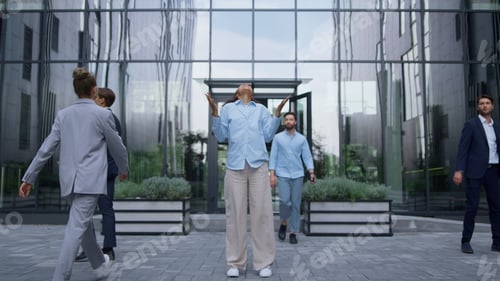 Preview: Successful corporate worker celebrating triumph laughing in urbanistic workplace