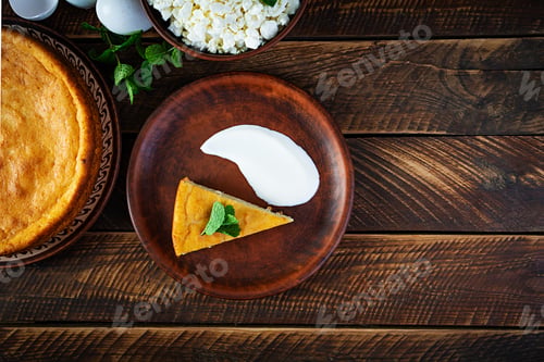 Preview: Homemade cottage cheese casserole on rustic wooden background. Top view