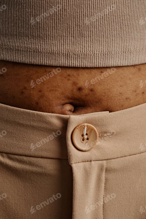 Preview: Close up detail shot of womans stomach with skin texture and belly button
