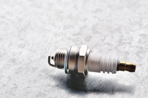 Preview: New spark plug for internal combustion engine on metal backgroun