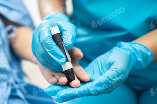 Preview: Doctor check diabetes from finger blood sugar level with finger lancet.