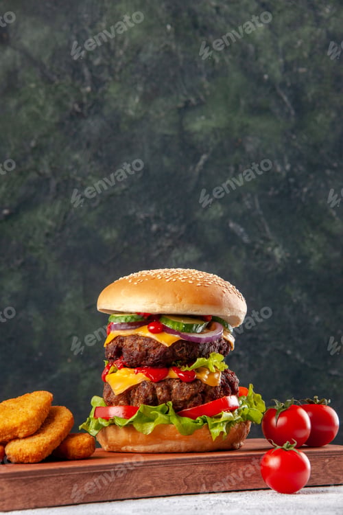 Preview: Homemade tasty sandwich and tomatoes chicken nuggets tomatoes on wooden cutting board on blurred