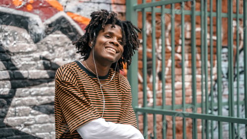 Preview: Portrait of young handsome dancing stylish black man with natural hair afro dreadlocks. Afroamerican
