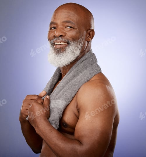 Preview: African man, towel and portrait in studio for shower, wellness or skincare by purple backdrop. Happ