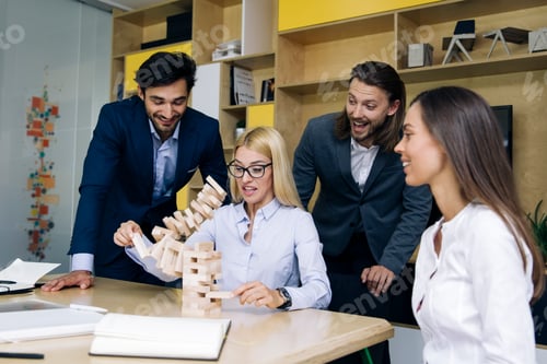 Preview: Team of young business people build a wooden construction