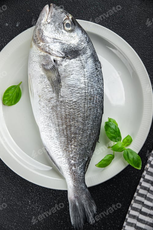 Preview: raw fish sea bream seafood fresh cooking snack appetizer meal food on the table copy space food