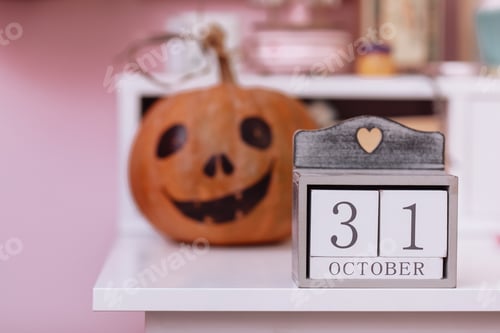 Preview: Wooden calendar show date 31 october halloween day and pumpkin on wooden school table in the