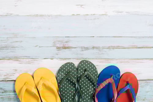 Preview: Colorful Flip Flops on a White Wood Background