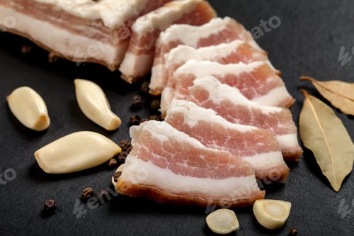 Preview: Fresh bacon with garlic and peppercorns, bay leaf. Ukrainian traditional cuisine.